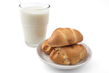 Fresh bavarian pastries rolls, on white plate with glass of yogurt, kifla kiflice, isolated on white background