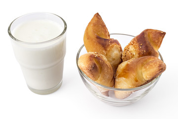 Fresh Serbian pastry rolls with cheese and sesame, in the glass bowl with glass of yogurt, kifla...