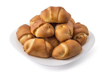 Fresh bavarian pastries rolls, kifla kiflice, on white plate, isolated on white background
