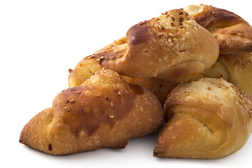 Fresh Serbian pastry rolls with cheese and sesame, kifla, kiflice, isolated on white background