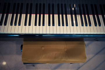 Top view of piano keyboard and chair.     