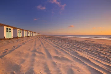 Gordijnen Row of beach huts at sunset, Texel island, The Netherlands © sara_winter