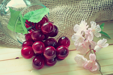 sacks and grapes and pink flower on wood background.effcet vinta