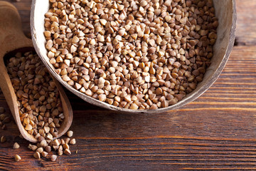 Buckwheat in bowl on wooden table