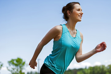 Fit woman jogging in park.