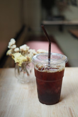 Iced Americano black coffee on a wooden table