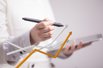 Businesswoman working with growth graph on grey background