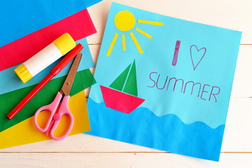 Card with text I love summer. Paper ship, sun, sea applique. Vacation pattern. Red pen, glue stick, scissors, colored paper. Fun art idea for kids. Summer vacation background. Summer vacation concept