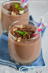 chocolate smoothie with banana, blueberries and almonds on a con