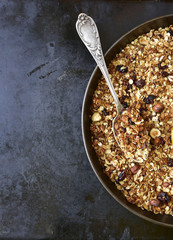 Homemade granola on a black metal tray.Top view.