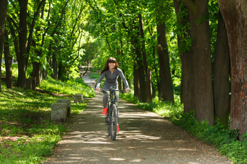 Fototapeta premium cyclist woman riding a bicycle in park