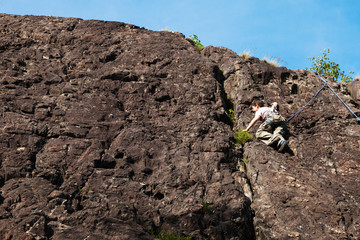 child climbs on rock wall