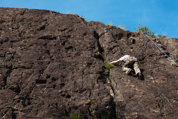 child climbs on rock wall