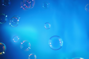 Rainbow soap bubbles on a blue backgrounds