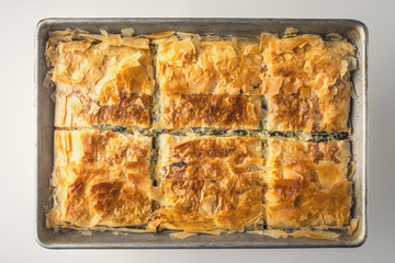 Greek pie spanakopita in the metal pan top view