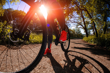 Young woman having fun riding a bicycle in the park.