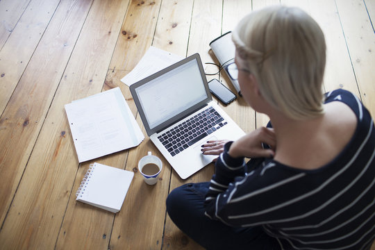 Young Female Entrepreneur Working At Home On Laptop
