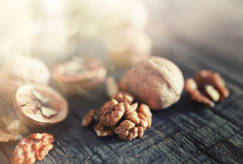 walnuts, whole and peeled wooden background