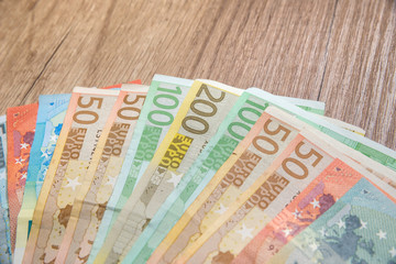 euro banknotes on wooedn background