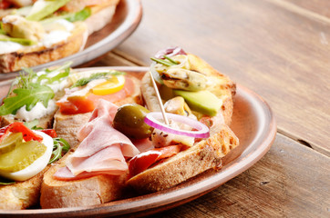 Open sandwiches with salmon, eggs, mussels, jamon and herring