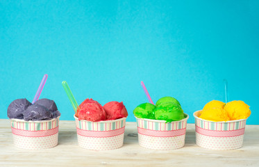Delicious fruit ice sorbet in paper cups - obrazy, fototapety, plakaty