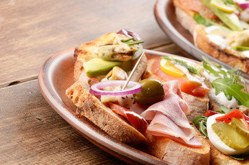 Open sandwiches with salmon, eggs, mussels, jamon and herring