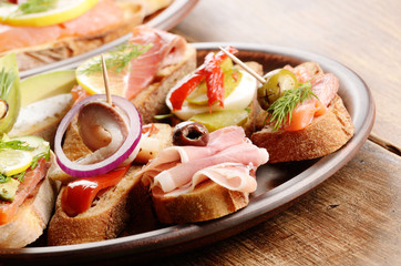 Open sandwiches with salmon, eggs, mussels, jamon and herring