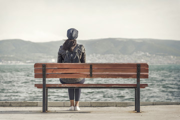 Girl on the bench near the sea. © Denis Rozhnovsky