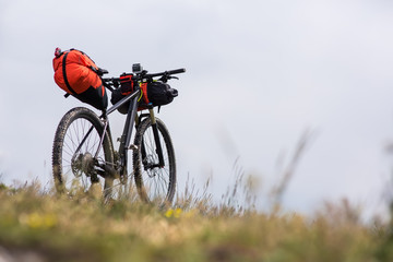 Fototapeta na wymiar Bicycle with orange bags for travel