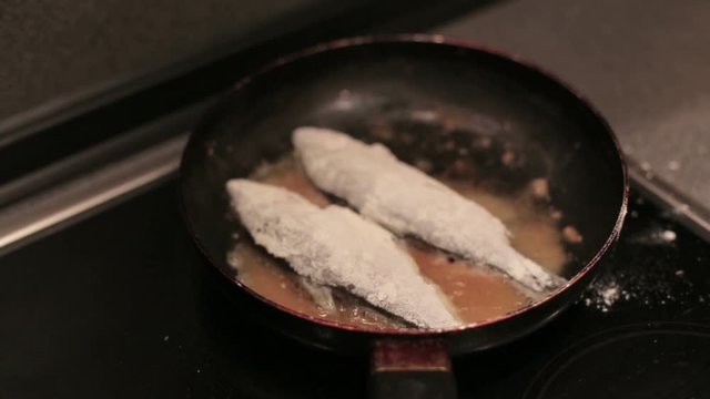 Breaded haddock being fried in a pan