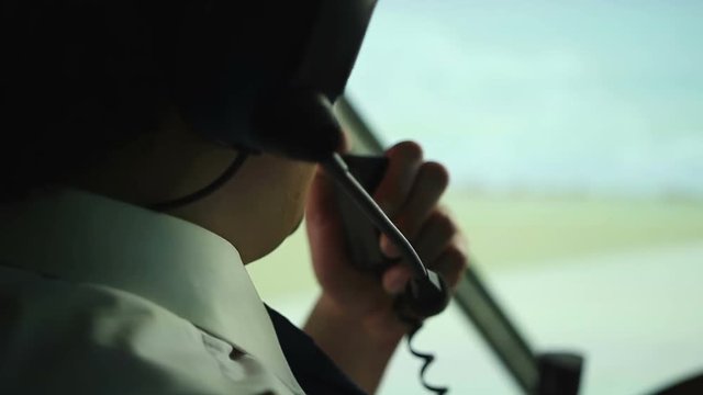 Civil aviation pilot using radio for communication with air traffic controller