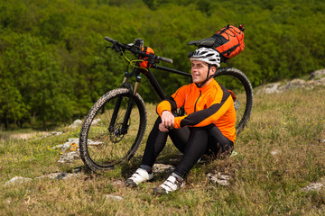 View of a Young Man With Bicycle on Summer Background.