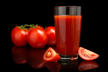 Tomato juice with tomatoes,green twig on black