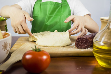 boy chef preparing raw dough