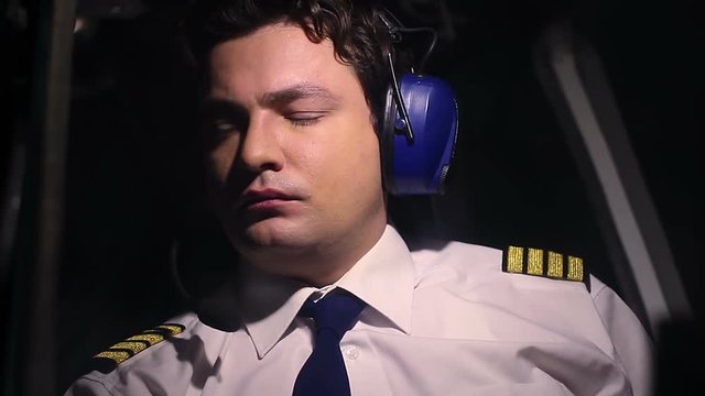 Male pilot feeling bad on board of airplane, suffering headache, human factor