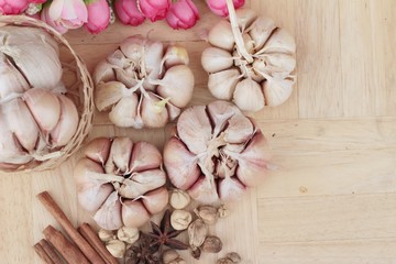 Fototapeta na wymiar Garlic has health benefits on wood background.