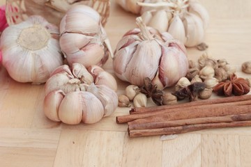 Garlic  has health benefits on wood background.
