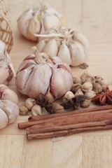 Garlic  has health benefits on wood background.
