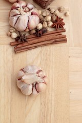 Garlic  has health benefits on wood background.