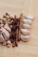 Garlic  has health benefits on wood background.