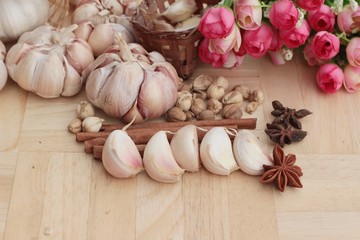 Garlic  has health benefits on wood background.