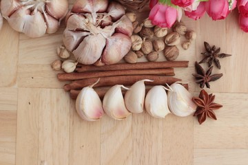 Garlic  has health benefits on wood background.