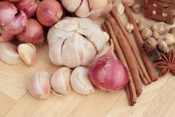 Shallot and garlic for cooking on wood background.