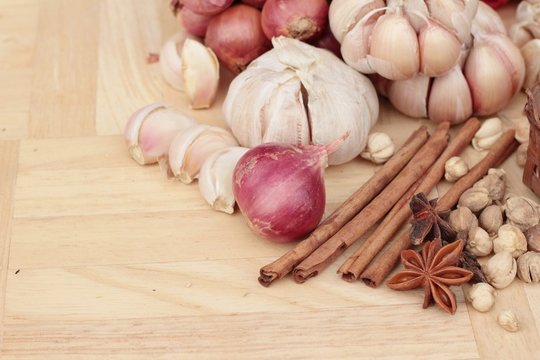 Shallot and garlic for cooking on wood background.