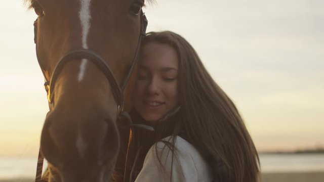 Young Girl Stroking and Hugging a Horse. Shot on RED Cinema Camera.