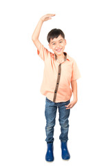 Little boy checkin his height on white background