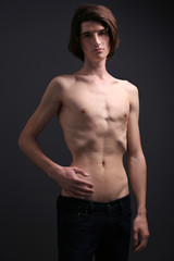 Obraz na płótnie Canvas Skinny young man with anorexia on dark background