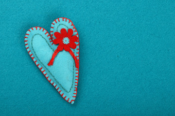 Felt craft and art teal heart with flower on blue