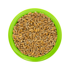 Small bowl filled with organic spelt isolated on a white background top view.