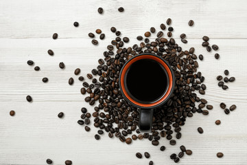 Cup of hot coffee on wooden surface